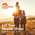 A family of four, two adults and two children, watching the sunset in a golden field. Sundance Vitamins logo.