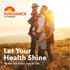 Family of four, including a man, woman, and two children, embracing in a sunny field, promoting Sundance Vitamins.