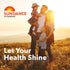 Family (man, woman, two children) embracing in a sunny field with Sundance Vitamins logo and 'Let Your Health Shine'.
