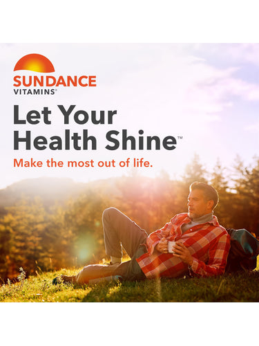 Middle-aged man relaxing on grass with a mug, backpack beside him, in sunny outdoor setting for Sundance Vitamins.