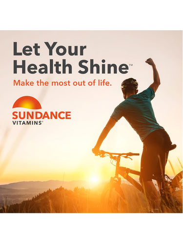 Adult male cyclist on a mountain bike, arm raised in triumph at sunset, with Sundance Vitamins logo visible.