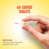 A quarter-inch long, light yellow tablet held between fingers.