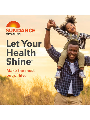 A man carries a young girl on his shoulders, both smiling, in a sunlit field of tall grass.