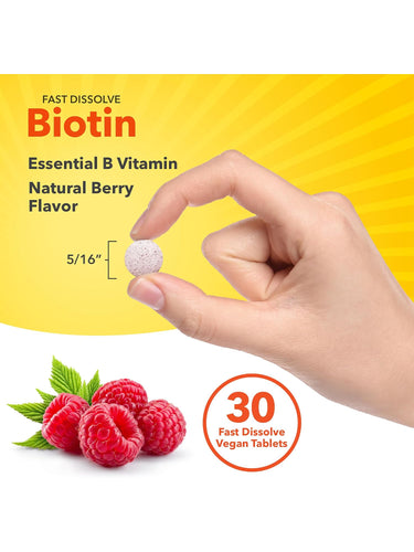Round speckled Biotin tablet, 5/16 inches, held between fingers.