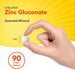A white vegan Chelated Zinc Gluconate tablet held between fingers, demonstrating its 1/4 inch diameter.