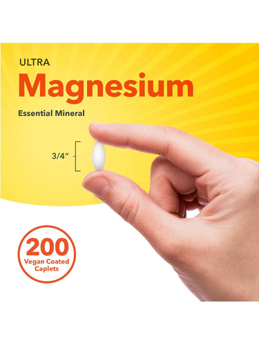 Vegan Ultra Magnesium caplet, 3/4'' long, shown held between fingers for size reference.