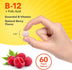A vegan tablet of B-12 + Folic Acid in natural berry flavor, measuring 1/4 inch, held between two fingers.