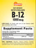 A hand holding a B-12 1000 mcg fast dissolve tablet.